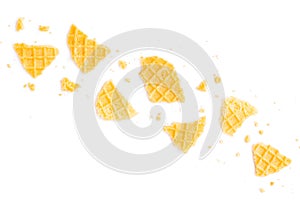 Broken crispy waffles isolated on a white background