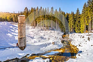 Broken dam in winter mountains