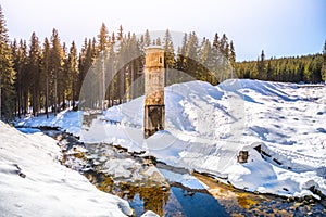 Broken dam in winter mountains