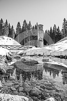 Broken dam in winter mountains