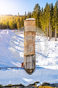 Broken dam in winter mountains