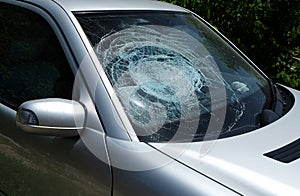 Broken damaged car windshield glass window.