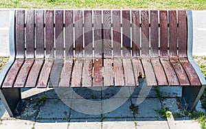 Broken and damaged wooden bench on the street, vandalism concept
