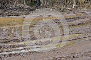 Broken dirt road after heavy rain. Swampy lagoon of a road demonstrates the most common problem in maintaining rural roads