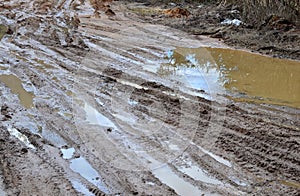 Broken dirt road after heavy rain. Swampy lagoon of a road demonstrates the most common problem in maintaining rural roads
