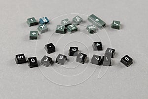 Broken and disassembled calculator buttons on gray background. S