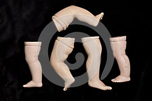 Broken Doll Parts on Black Background