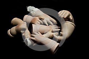 Broken Doll Parts on Black Background