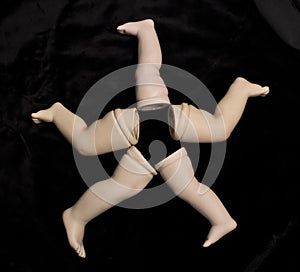 Broken Doll Parts on Black Background