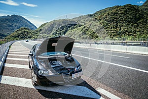 Broken down car on the highway, engine bonnet