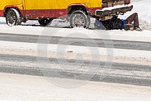 a broken down car on the side of a winter road. a man fixes a minivan