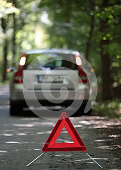 Broken down car with warning triangle