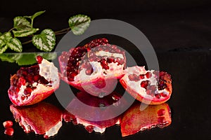 Broken down into pieces red ripe pomegranate