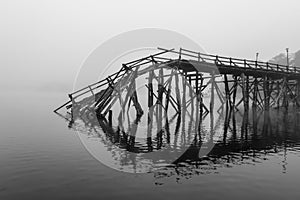 A broken down wooden bridge