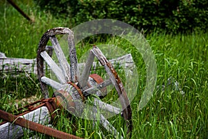 Broken-Down Wooden Wagon Wheel in the Grass