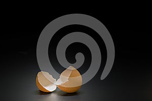 broken egg on black background and space for text on center