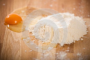 Broken egg on flour