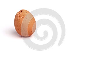 Broken egg isolated on white background. Brown shell. Copy space