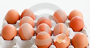 A broken egg surrounded by other eggs.