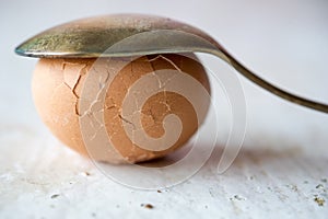 Broken egg on white table