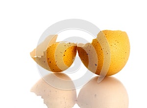 Broken eggshell over white background