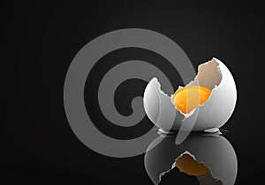 Broken eggshell with raw egg on a black minimalist surface reflective background