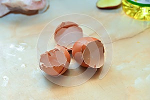 Broken eggshell of three eggs lies on the table in the kitchen at home