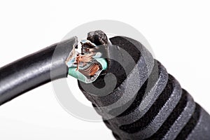 Broken electrical wire with a plug on a white background, isolate, close-up. Electric shock