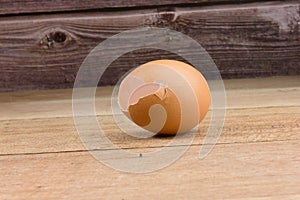 Broken empty egg shell on wooden surface