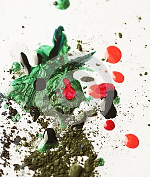 Broken eye-shadows and drops of nail lacquer