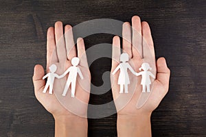 Broken family concept, divorce. Child hands with broken paper cut fmily