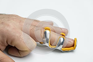 Broken finger in splint isolated white background