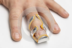 Broken finger in splint isolated white background