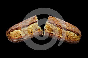 Broken fresh baguette on black background, french baquette menu design