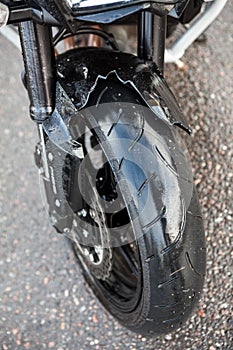 Broken front plastic fender of motorcycle due road accident, close up view