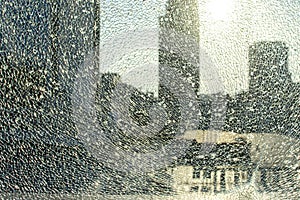 Broken glass against the background of the city, bullet holes