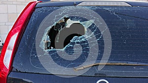 Broken glass in back door of car. Smashed rear window of auto