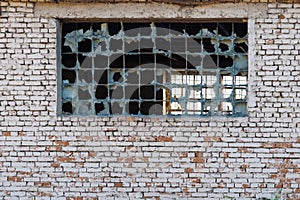 broken glass block window in white brick wall texture and background