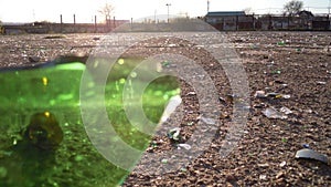 Broken glass bottles of beer and alcohol on the sidewalk. Urban pollution by glass. Environmental vandalism. Broken glass on