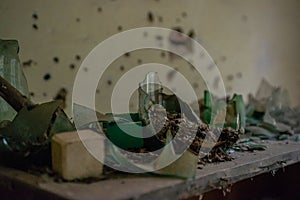 Broken glass bottles in the kindergarten at the abandoned village Kopachi near Chernobyl