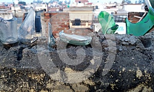Broken glass bottles on top of a wall for security against intruders or burglars. photo