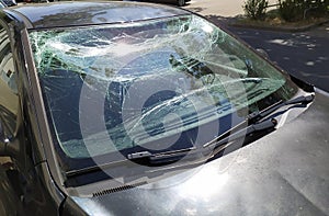 Broken glass of the broken windshield after a heavy car accident ruined the windscreen and caused an injury that shattered