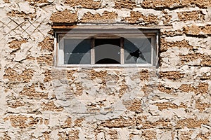 Broken glass in a building window. Housing problems