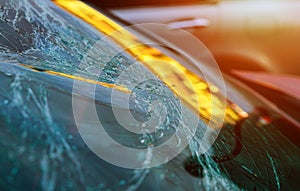 Broken glass on a car with broken windshield after crash accident