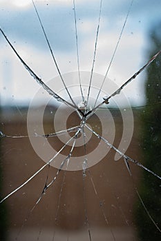 Broken glass close up. Shuttered window. Violence and vandalism concept. Damaged window. Danger background.