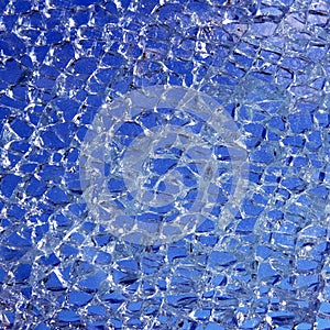 Broken glass cracked over blue background