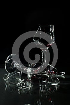 Broken Glass Cups with Reflection on a Glass Table Isolated On Black
