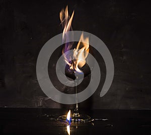 Broken glass on fire on textured background