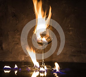 Broken glass on fire on textured background