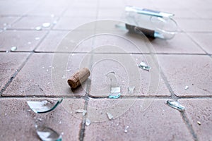 Broken glass on the floor, alcohol abuse